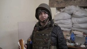 Artem Ryzhykov standing in military gear in a still from A Simple Soldier.