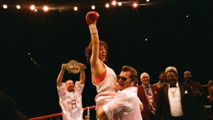 Sydney Sweeney as Christy Martin, being held up in a boxing ring with one red glove in the air, in "Christy"